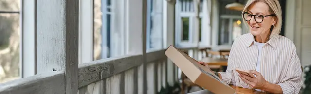 Frau mit Paket auf Veranda