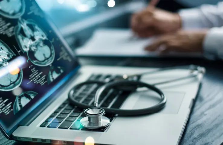 Laptop, auf dem ein Stethoskop liegt