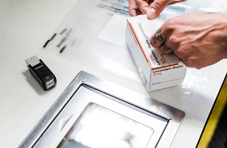 Medikamentenpackung, die mit Einnahmeinformationen beklebt wird
